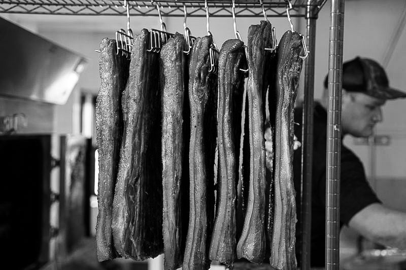 Bacon hanging in Black Sheep Bacon Warehouse